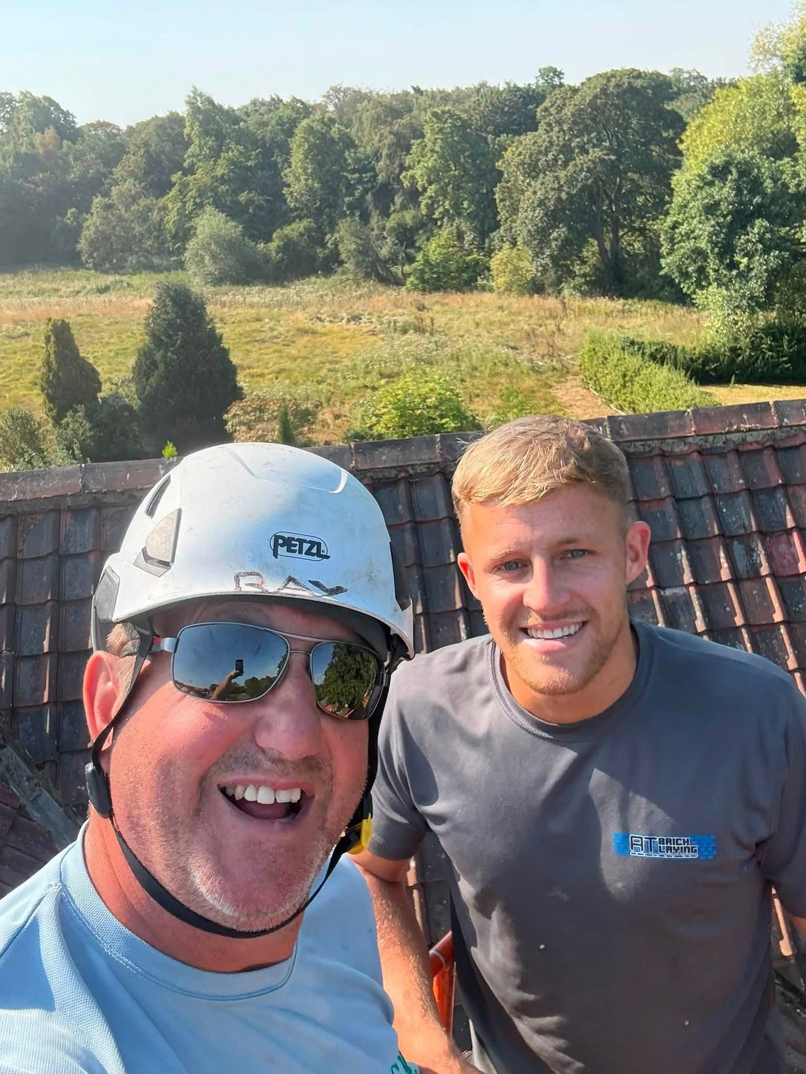 Ray and the IGM team in branded shirts and hard hats on a commercial roof in Teesside
